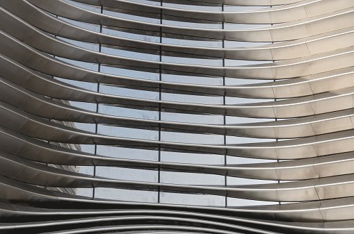 Abstract reflection of office buildings in curved glass