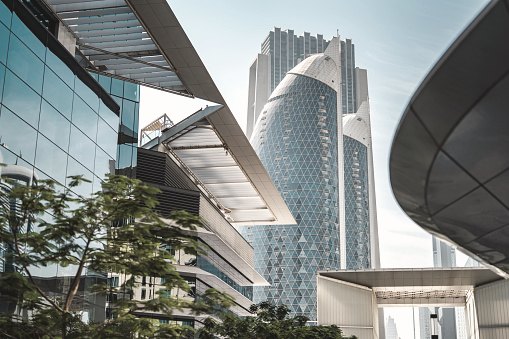 Curved glass tower rising above surrounding buildings